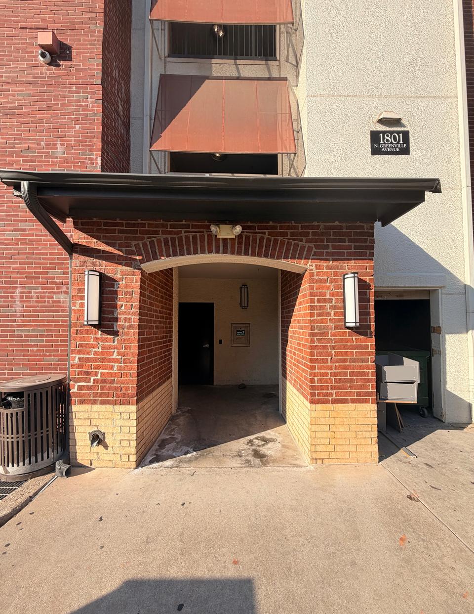 The back entrance: a brick archway under the 1801 N Greenville Avenue sign