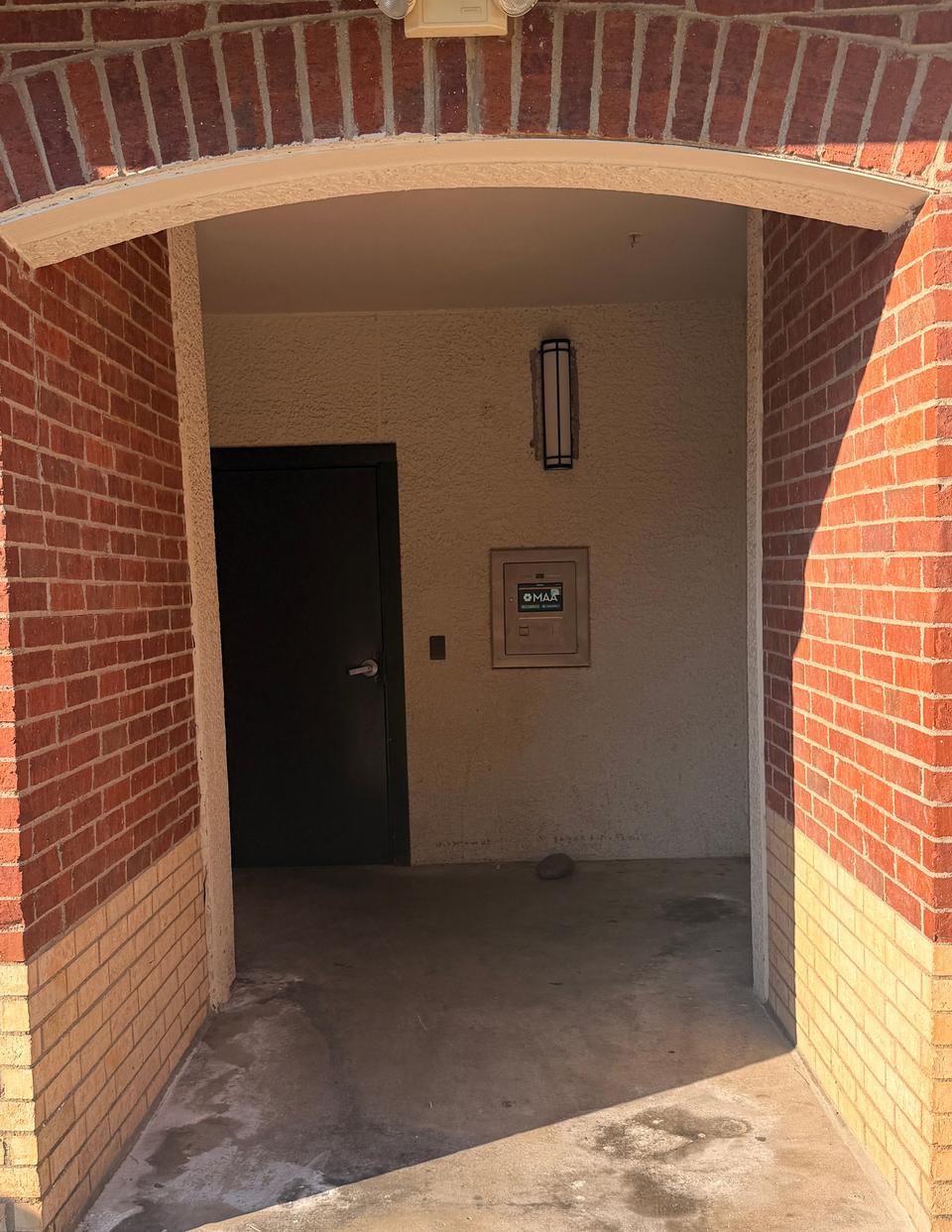 The archway close up, with the call box on the wall right of the door